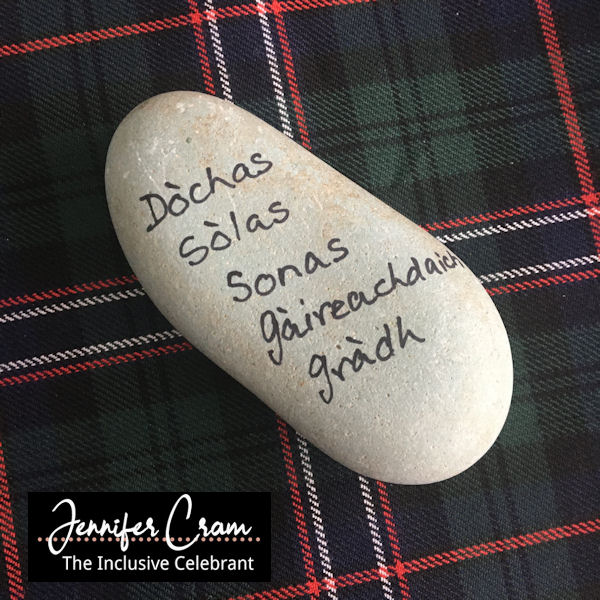 Oathing Stone with commitments written in Gaelic
lying on the Scottish Nation Tartan
